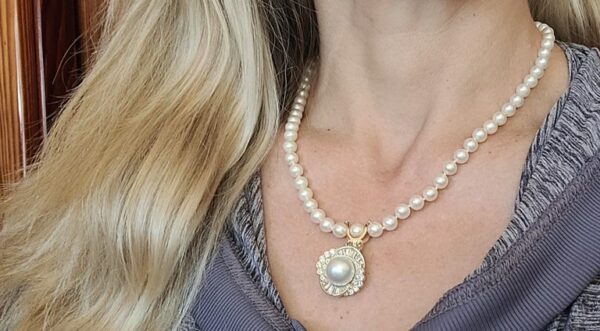 showcasing pearl enhancer pendant on model