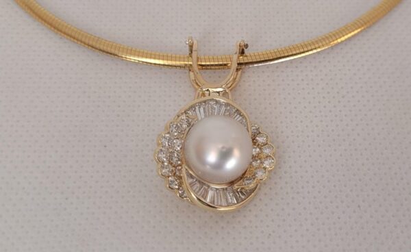 showcasing 14kt yellow gold pearl diamond enhancer on omega chain
